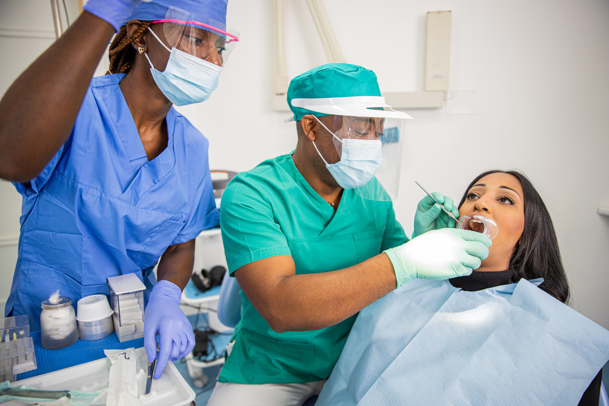 Dentist examining patient's teeth during routine dental checkup in Tulsa clinic.
